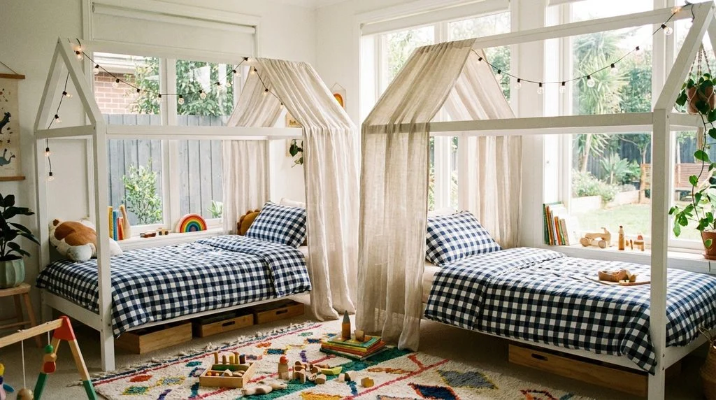 Two house-frame beds in a shared kids' bedroom, one draped with a curtain for added privacy.