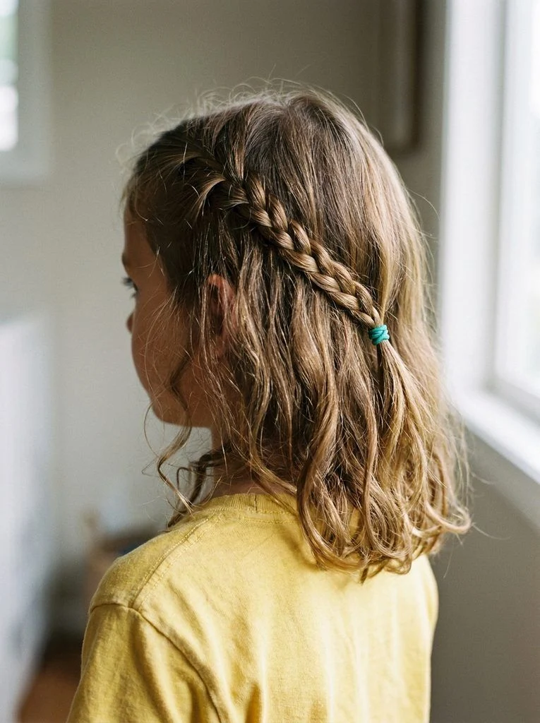 One small front accent braid beside loose shoulder-length waves.