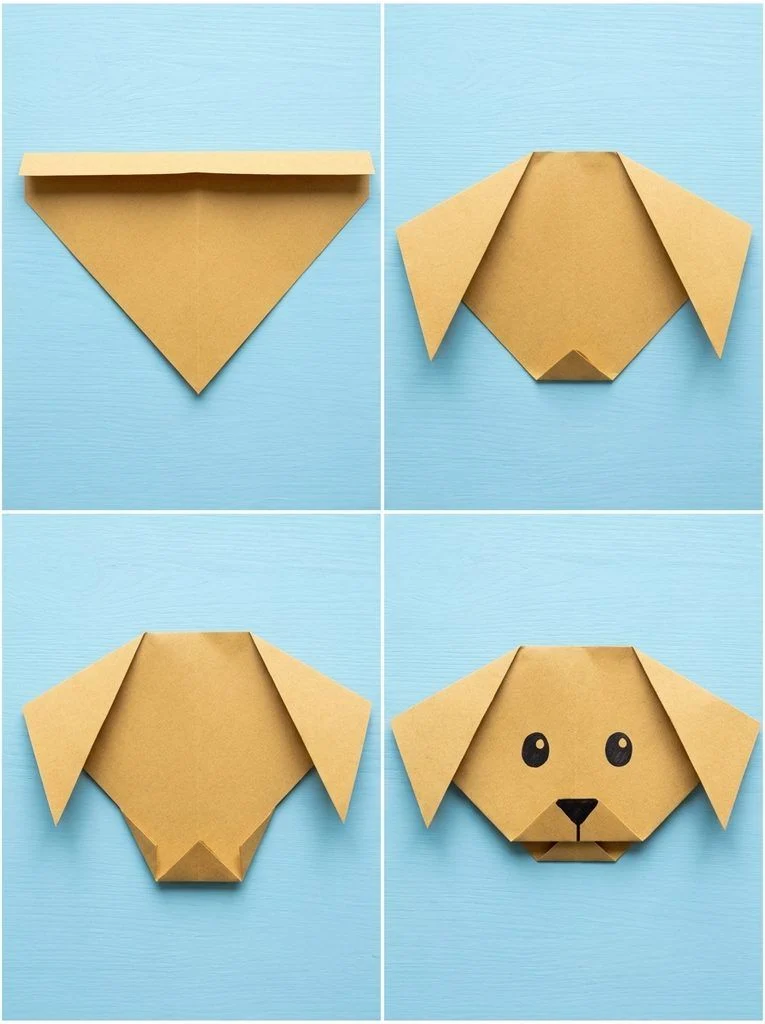 Paper triangle folded into a dog face with floppy ears and drawn features.