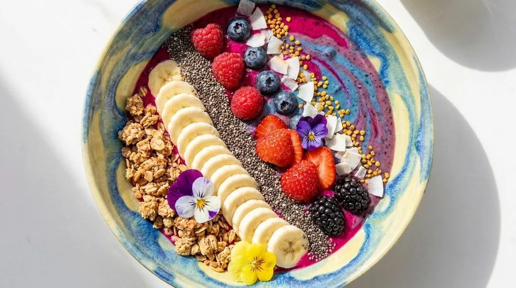 A high-protein smoothie bowl topped with fruit, granola and seeds